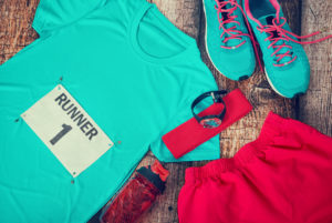 Running gear laid out ready for a race day, rustic wooden background